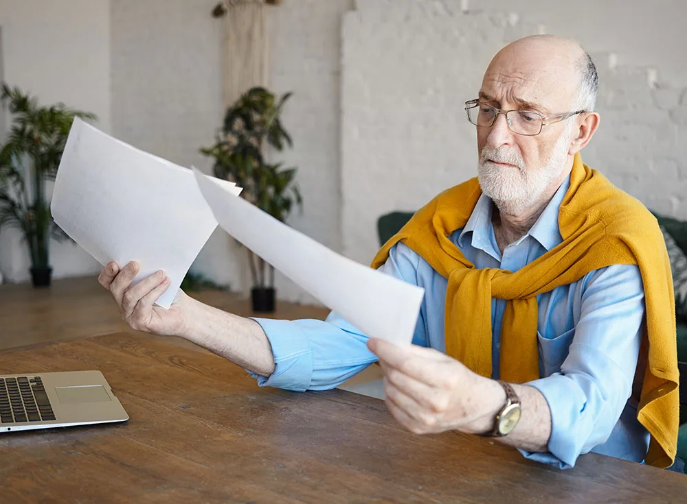 attractive experienced sixty year old man accountant holding papers attractive experienced sixty year old man accountant holding papers