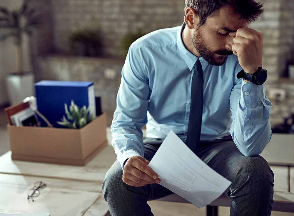 young frustrated businessman holding young frustrated businessman holding